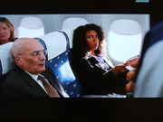 The woman is sitting by the window